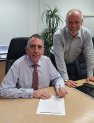 Qenos CEO Stephen Bell and Paul Kennedy sign<br>the Safety Case submission earlier this year.